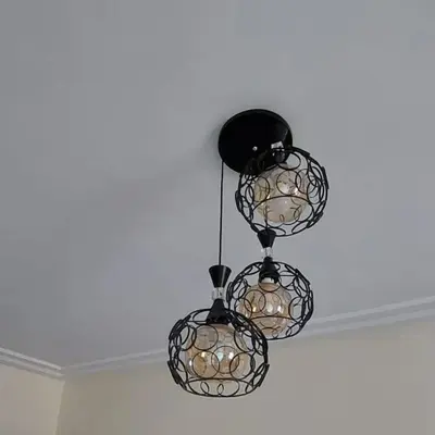 two black chandeliers hanging from a ceiling at Apartment in Marrakech - WiFI - IPTV Movies - equipped - free parking in Marrakech