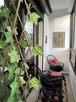 a large green plant in a room with chairs at Superbe studio en plein centre in Marrakech