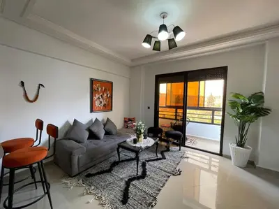 a living room with a couch and a table at Superbe studio en plein centre in Marrakech