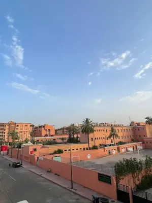 a view of a street with buildings and palm trees at Superbe studio en plein centre in Marrakech