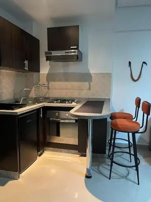 a kitchen with a stove and a table and chairs at Superbe studio en plein centre in Marrakech