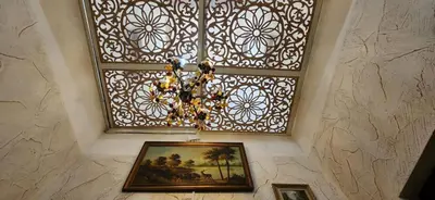 a painting on a wall with a window and a picture at Appartement Riad 5min à pied de l'aéroport in Marrakech