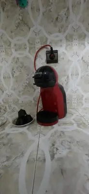 a red telephone sitting on top of a marble floor at Appartement Riad 5min à pied de l'aéroport in Marrakech