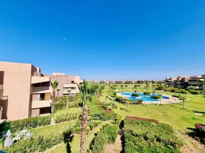 an aerial view of a resort with a swimming pool at Appartement Spacieux et Moderne avec une Vue sur Montagne et Piscine in Marrakech