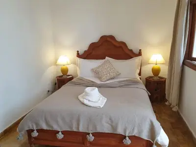 a bedroom with a bed with a hat on it at Riad Aslan Place des épices - en exclusivité, wifi in Marrakech