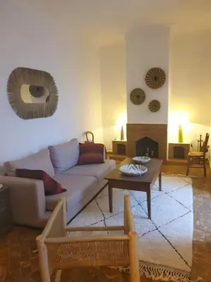 a living room with a couch and a table at Riad Aslan Place des épices - en exclusivité, wifi in Marrakech