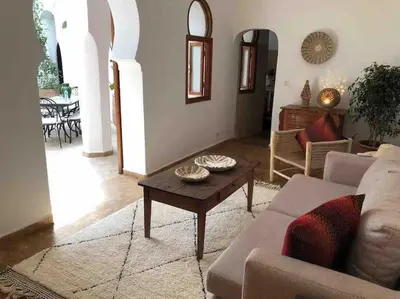 a living room with a couch and a coffee table at Riad Aslan Place des épices - en exclusivité, wifi in Marrakech