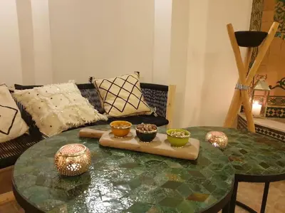 a living room with a glass table with bowls on it at Riad Aslan Place des épices - en exclusivité, wifi in Marrakech