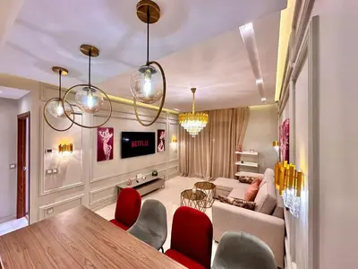 a living room with a couch and a table and chairs at Appartement Luxueux avec Piscine 10 minutes du centre ville in Marrakech