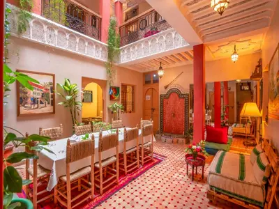 a restaurant with a table and chairs in a room at Riad Nakhla in Marrakech