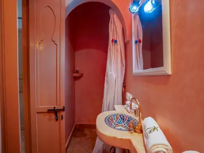a bathroom with a sink and a mirror at Riad Nakhla in Marrakech