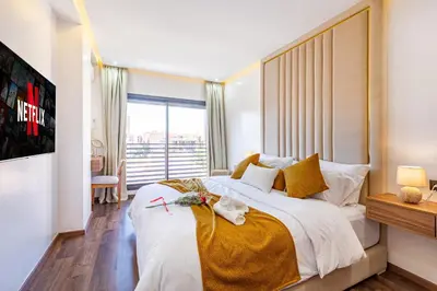 a bedroom with a large bed with a large window at Starlight Studio in Marrakech
