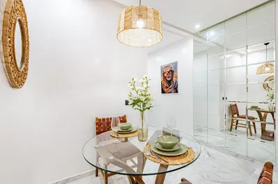 a dining room with a glass table and chairs at Starlight Studio in Marrakech