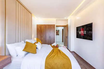 a bedroom with a large white bed with yellow pillows at Starlight Studio in Marrakech