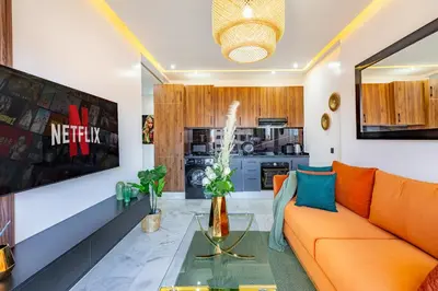 a living room with an orange couch and a table at Starlight Studio in Marrakech