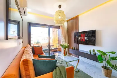a living room with an orange couch and chairs at Starlight Studio in Marrakech
