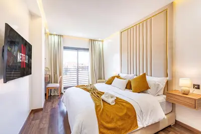 a bedroom with a large bed with a large window at Starlight Studio in Marrakech