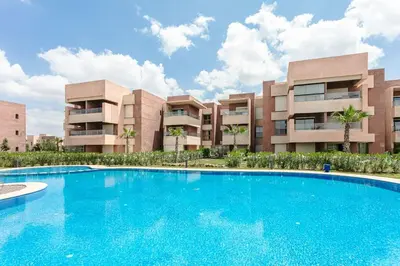 a large swimming pool in front of a building at Green Horizon Marrakech Prestigia in Marrakech
