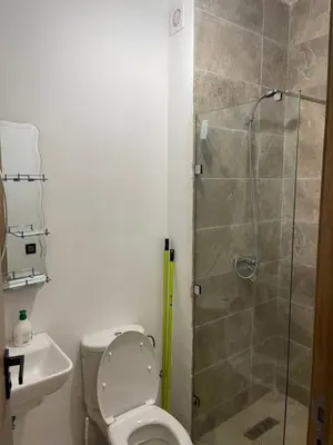 a bathroom with a toilet and a glass shower at Appartement à louer Marrakech in Marrakech