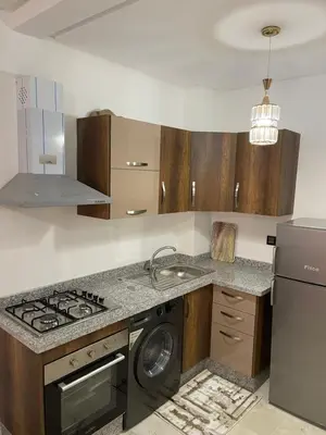 a kitchen with a stove and a washing machine at Appartement à louer Marrakech in Marrakech