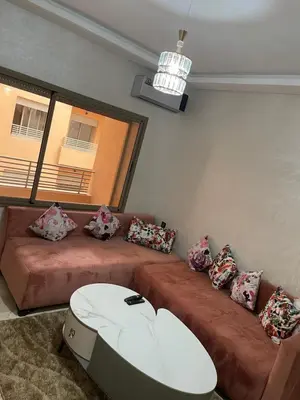 a living room with two couches and a table at Appartement à louer Marrakech in Marrakech