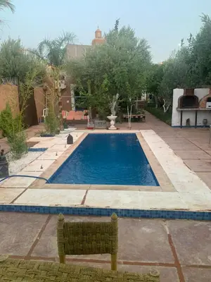 a large swimming pool in a yard with afficientfficientfficientfficientfficient at Maison coco in Marrakech