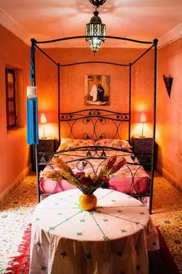 a bedroom with a bed and a table with a vase on it at Riad - In Medina - Kesh Design in Marrakech
