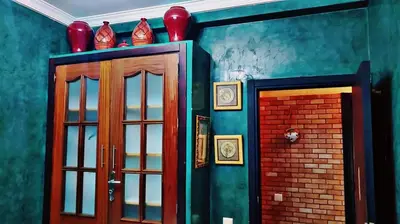 a room with a door and a brick wall at Cozy Bedroom Sidi maarouf in Marrakech