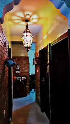 a hallway with a ceiling fan and a chandelier at Cozy Bedroom Sidi maarouf in Marrakech