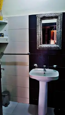 a bathroom with a white sink and a mirror at Cozy Bedroom Sidi maarouf in Marrakech