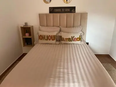 a bed in a room with a bed frame at Nour 5 in Marrakech