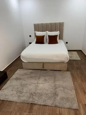 a bedroom with a large bed with two pillows at Nour 5 in Marrakech