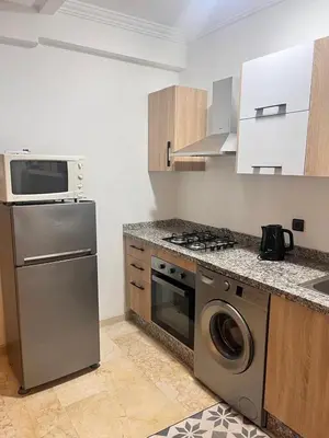a kitchen with a stove and a dishwasher at Nour 5 in Marrakech