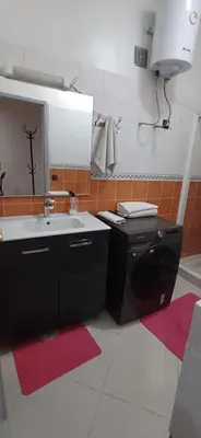 a kitchen with a sink and a mirror at Résidence Nadia 3 étage appartement 22 in Marrakech