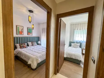 a bedroom with a bed and a mirror at Spacieux et luxueux appartement in Marrakech