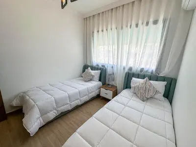 a bedroom with two beds and a window at Spacieux et luxueux appartement in Marrakech