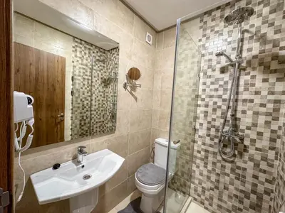 a bathroom with a toilet and a sink and a shower at Spacieux et luxueux appartement in Marrakech