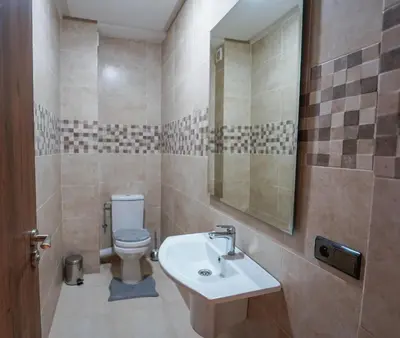 a bathroom with a sink and a toilet at Spacieux et luxueux appartement in Marrakech