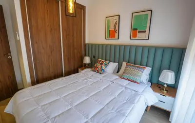 a bedroom with a large white bed with two pillows at Spacieux et luxueux appartement in Marrakech