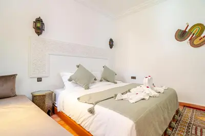 a bedroom with two beds with towels on them at Riad La Kasbah secrète - Piscine intérieure in Marrakech