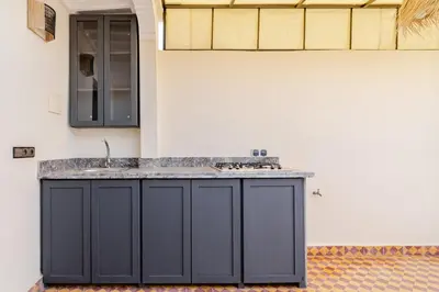 a kitchen with a counter with a sink at Riad La Kasbah secrète - Piscine intérieure in Marrakech