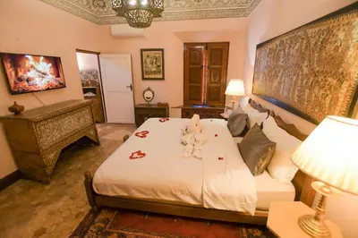 a bedroom with a bed with a teddy bear on it at Villa Riad luxe centre marrakech majorelle Rue Yves st laurent in Marrakech