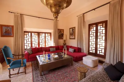 a living room with a red couch and a table at Villa Riad luxe centre marrakech majorelle Rue Yves st laurent in Marrakech