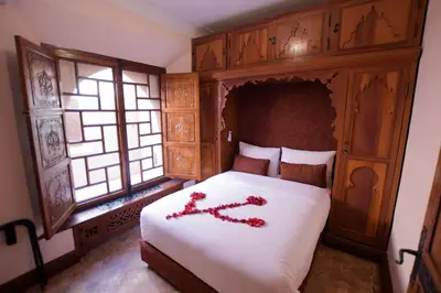 a bedroom with a bed with red flowers on it at Villa Riad luxe centre marrakech majorelle Rue Yves st laurent in Marrakech