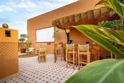 a patio with chairs and a table in a house at Riad Brothers in Marrakech