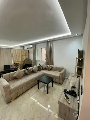a living room with a couch and a table at Centre ville T3 jacuzzi privé 2 min de la gare in Marrakech
