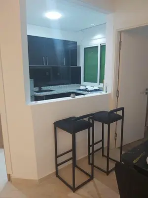 two black stools sitting at a counter in a kitchen at Centre ville T3 jacuzzi privé 2 min de la gare in Marrakech