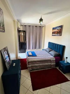 a bedroom with a blue bed and a window at Charmant Appartement à Gueliz - À Deux Pas des Attractions Locales in Marrakech