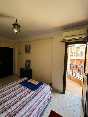 a bedroom with a bed and a large window at Charmant Appartement à Gueliz - À Deux Pas des Attractions Locales in Marrakech