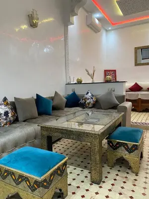 a living room with a couch and a table at Riad Camélia in Marrakech
